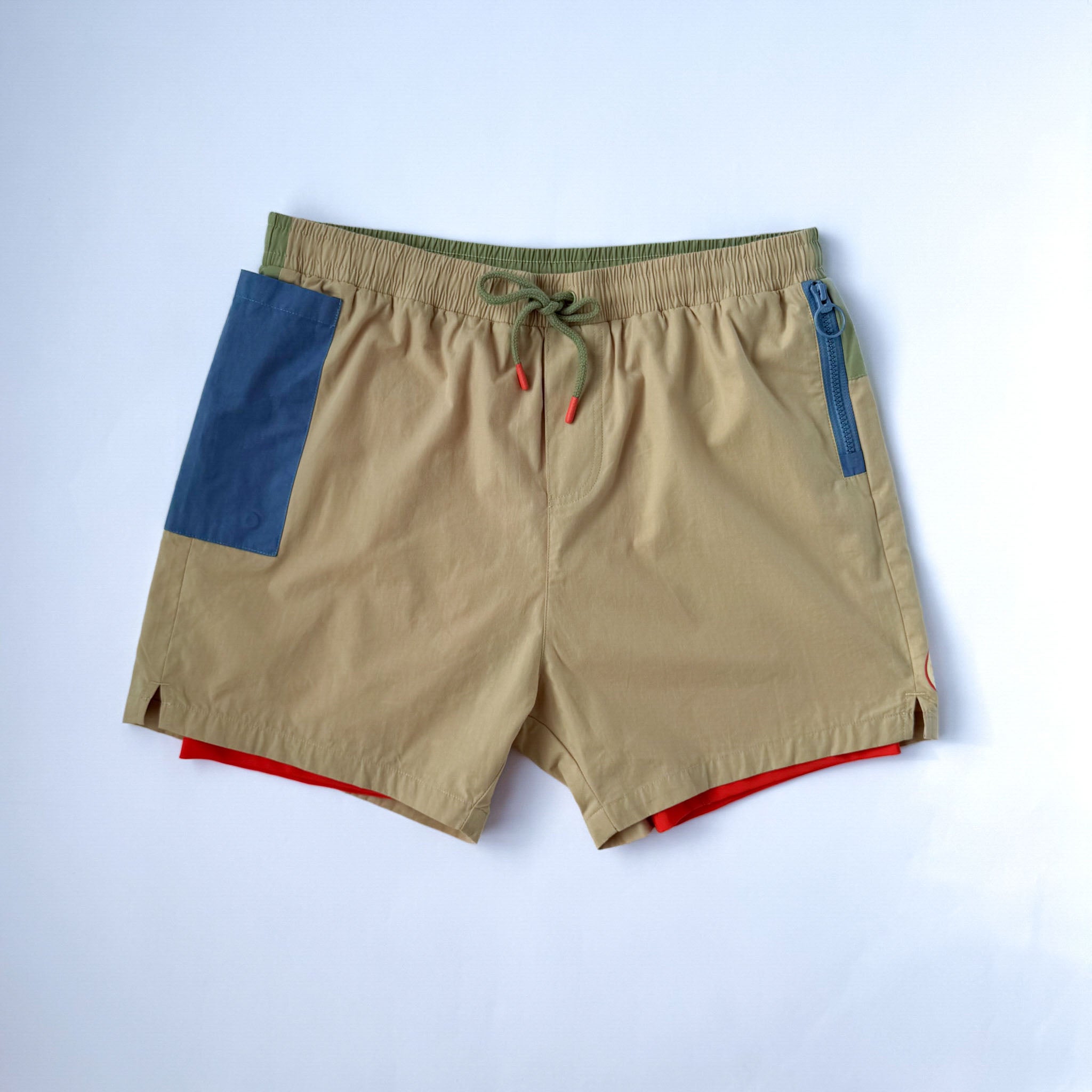 Men swimwear with blue phone pocket and red inner liner. Front view on white background.