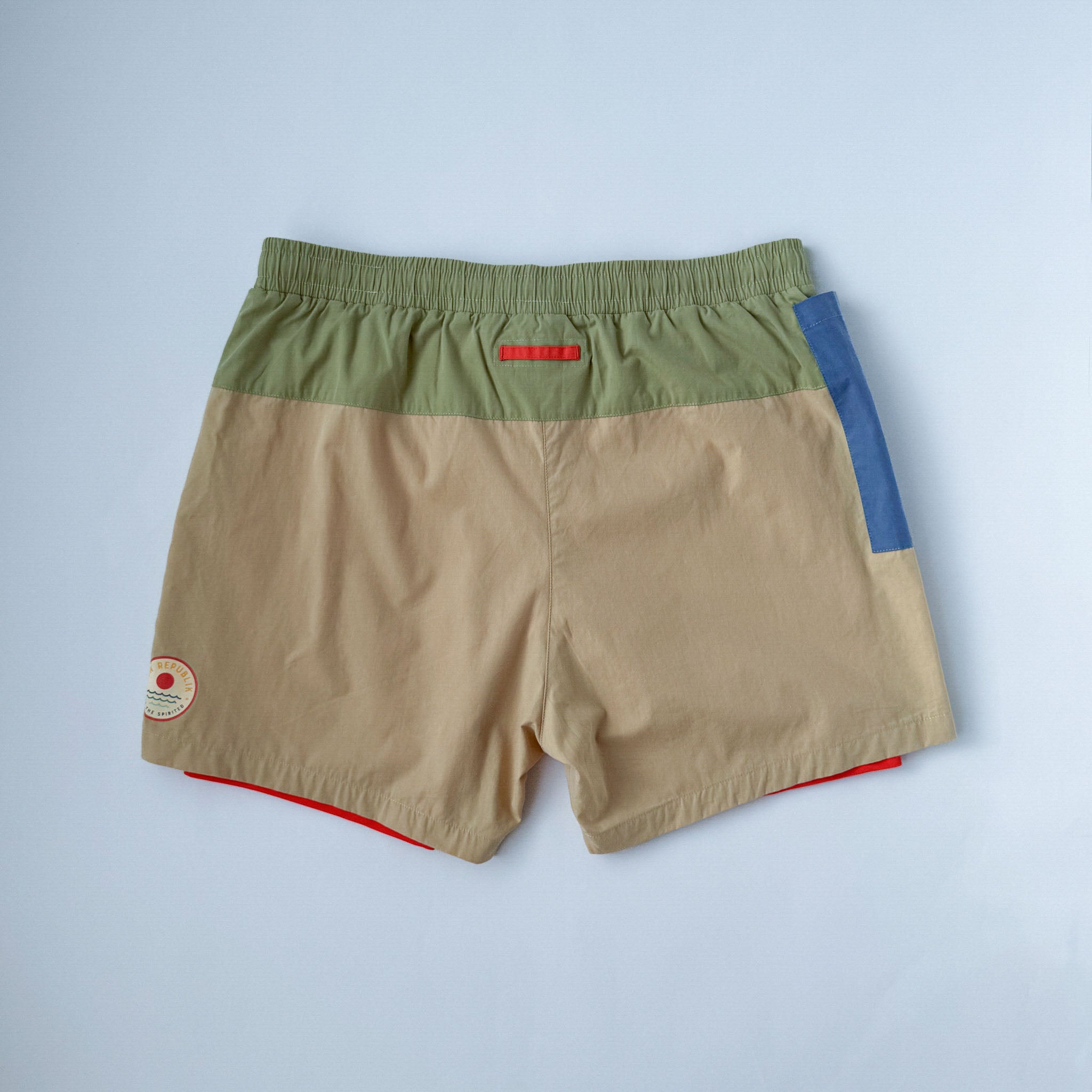 Swim shorts men with blue phone pocket and red inner liner. On white background.
