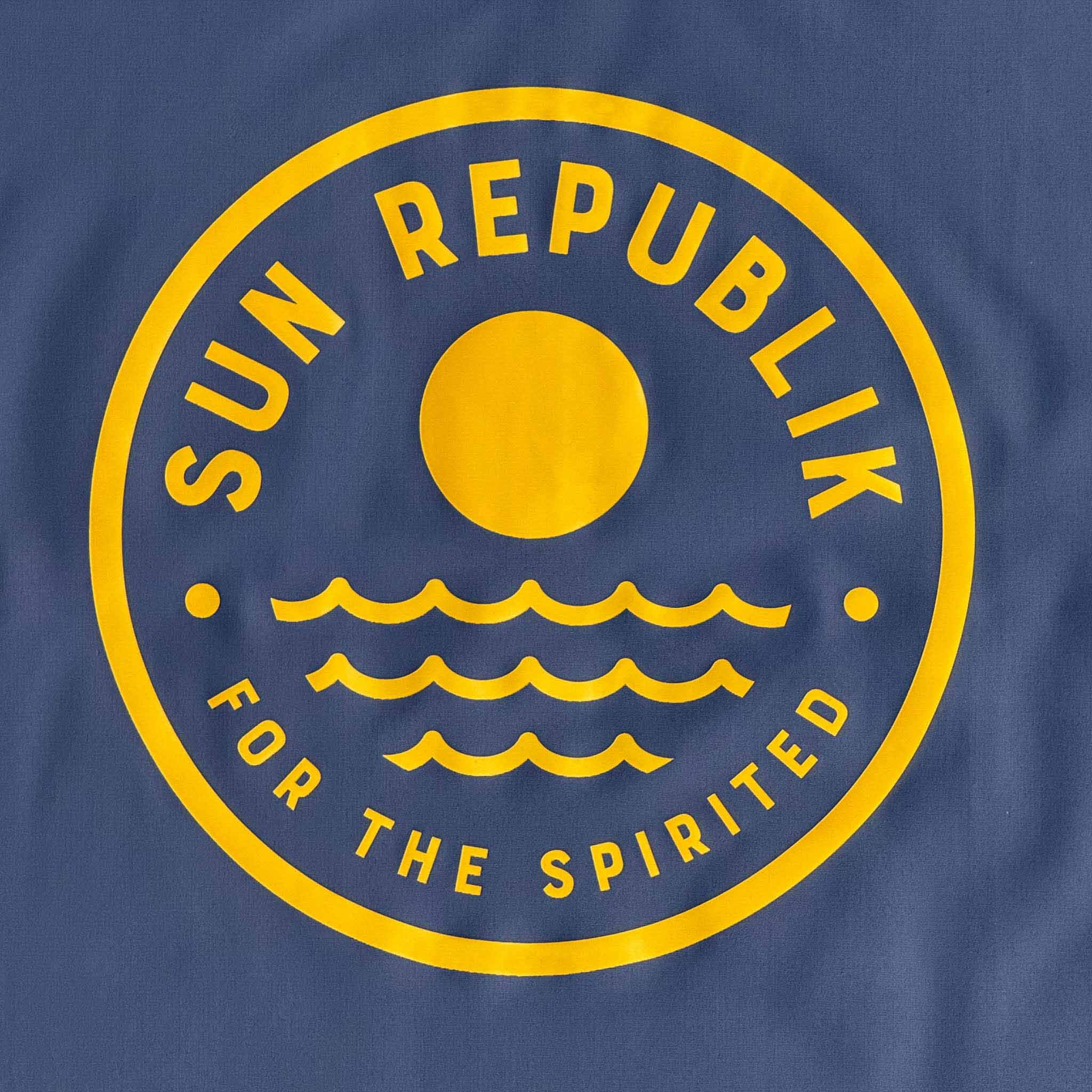 Round sun republik logo on mens beach wear rashie.