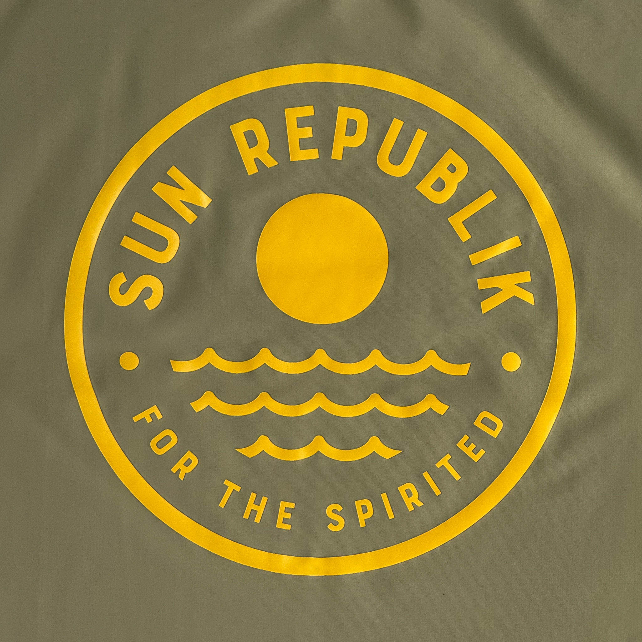 Back view of men swimwear swim top with round yellow sun republik logo.
