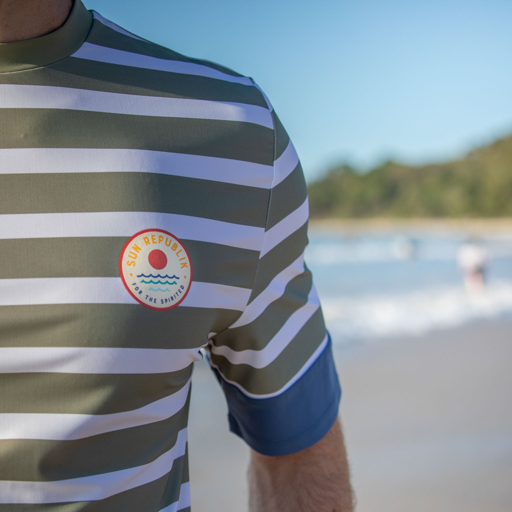 Cropped view of men swimwear rash guard, short sleeve with  logo detail.