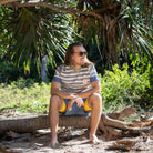 Men sat outside wearing mens beach wear swim top and shorts with inner liner. 